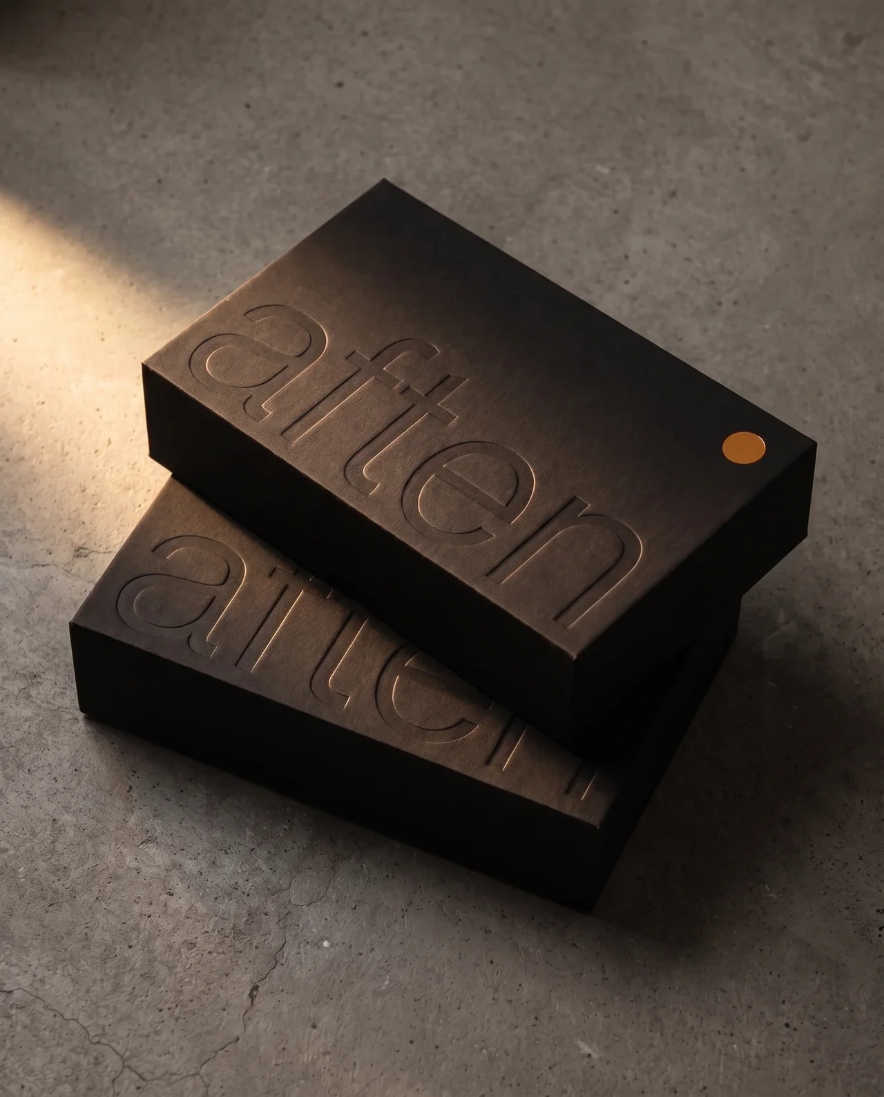 Closed AFTEN boxes stacked with their printed sleeves
